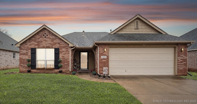 view of front of house with a garage and a yard