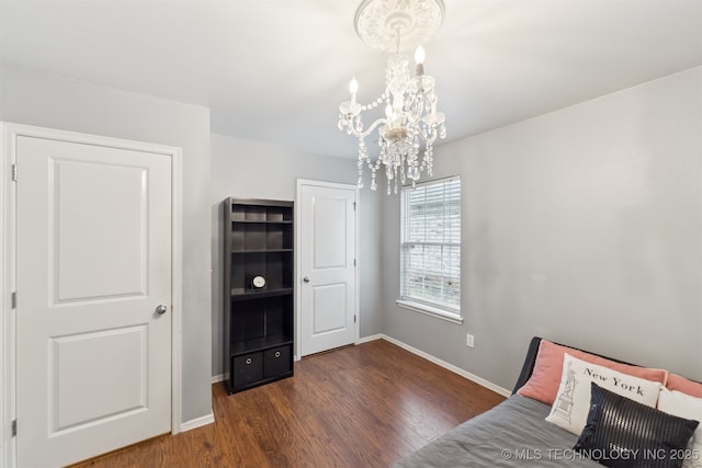 unfurnished bedroom featuring dark hardwood / wood-style floors and a chandelier