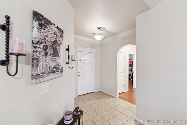 foyer entrance with light tile patterned flooring