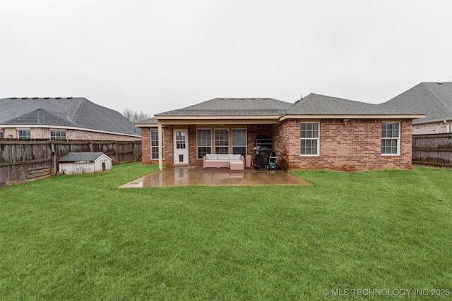 rear view of property featuring an outdoor hangout area, a patio area, a storage unit, and a lawn