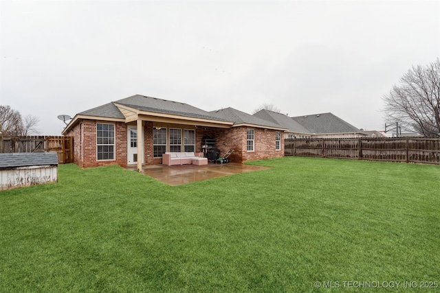 rear view of property with a patio and a lawn