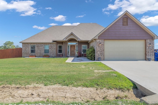 view of front facade with a garage and a front lawn