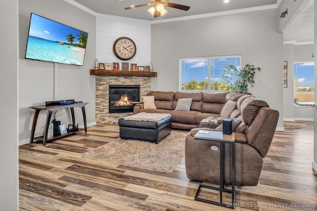 living room with hardwood / wood-style floors, crown molding, and ceiling fan