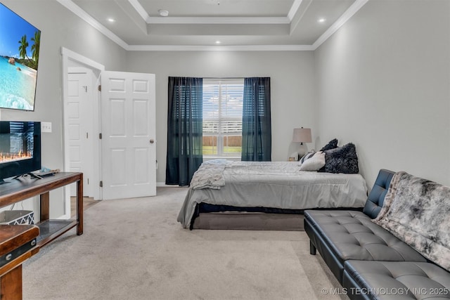 carpeted bedroom featuring ornamental molding and a tray ceiling