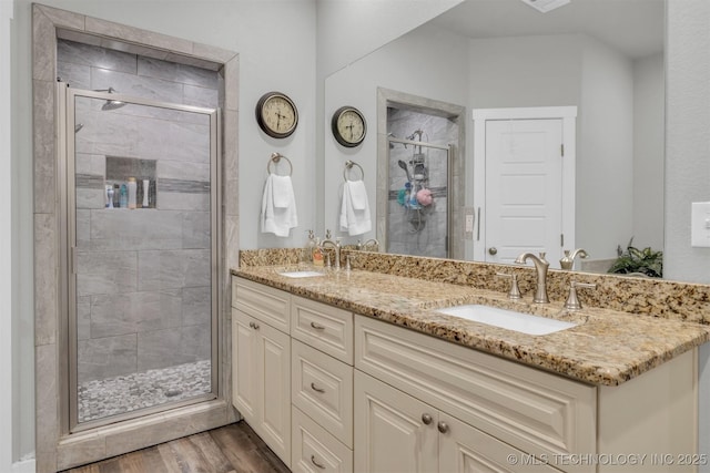 bathroom featuring walk in shower, vanity, and hardwood / wood-style floors