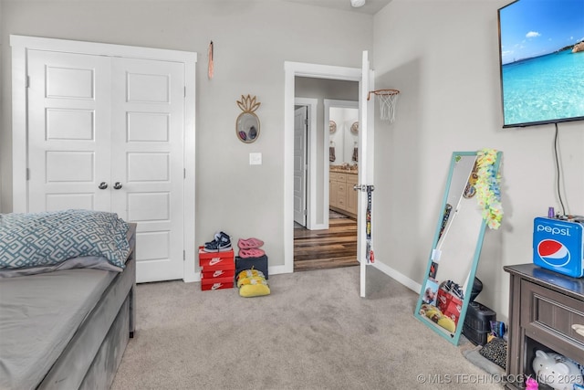 carpeted bedroom with a closet