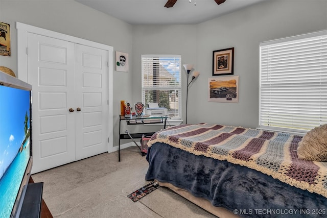 carpeted bedroom with a closet and ceiling fan