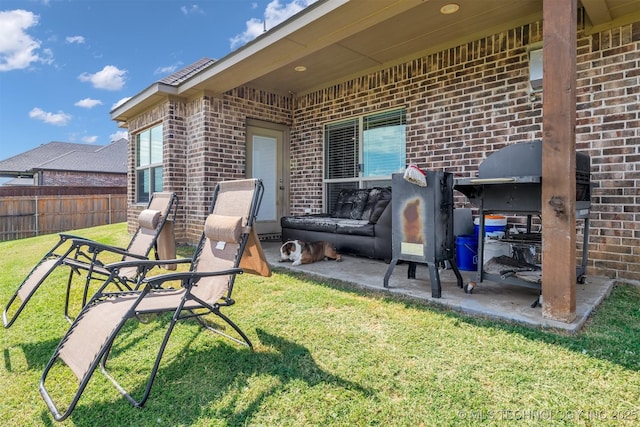 rear view of property with a yard and a patio