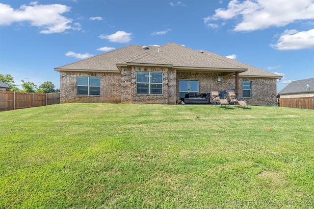 back of property featuring a lawn