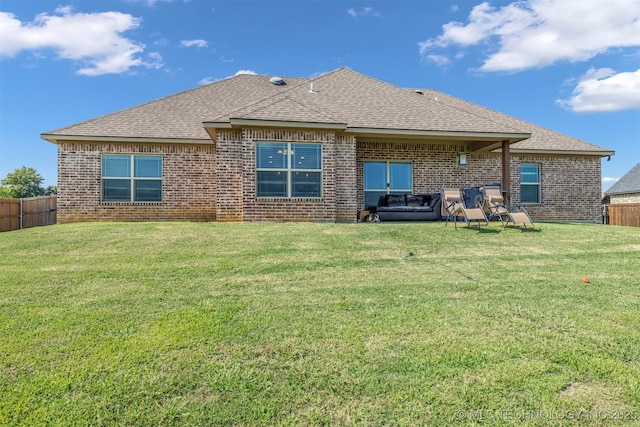 back of property featuring a lawn