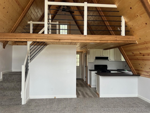 kitchen featuring black stove, high vaulted ceiling, and wood ceiling