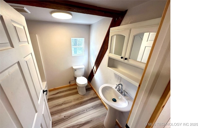 bathroom with wood-type flooring, shower with separate bathtub, and toilet