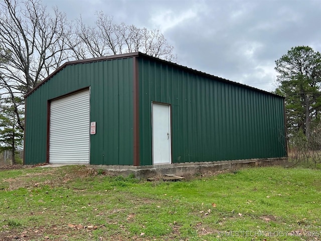 view of outbuilding with a yard and a garage