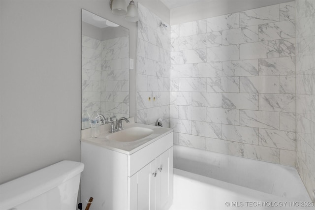 full bathroom with tiled shower / bath combo, vanity, and toilet