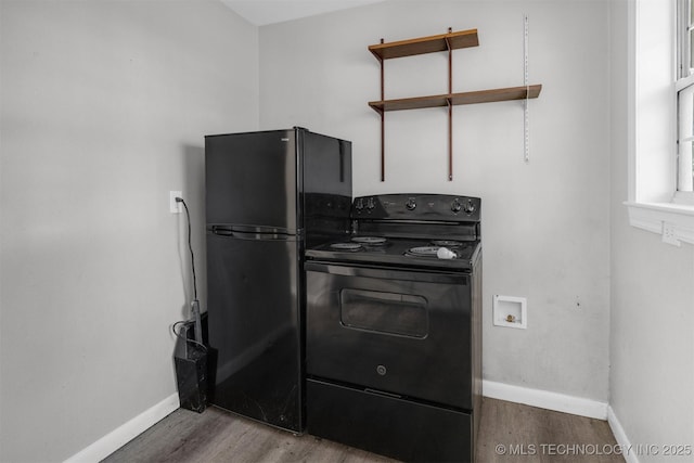 kitchen featuring hardwood / wood-style floors and black appliances