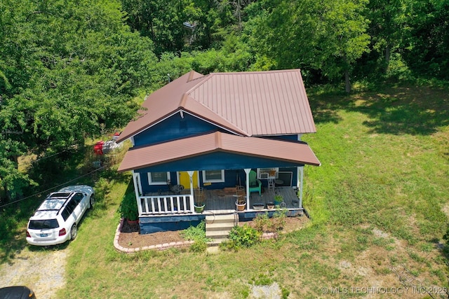 view of front of house with a front yard and a porch
