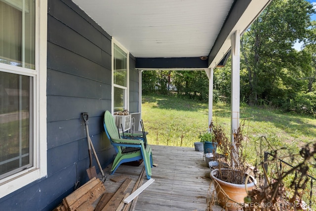 wooden deck featuring cooling unit and a lawn