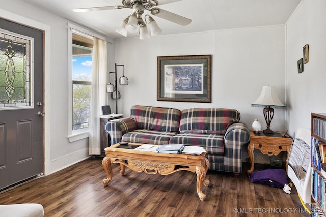 living room with dark hardwood / wood-style floors and ceiling fan