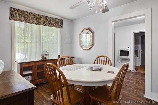 dining space with ceiling fan, dark hardwood / wood-style flooring, and heating unit