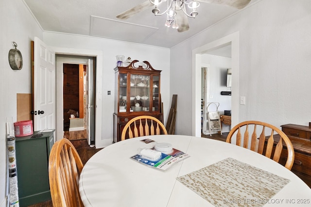 dining area with an inviting chandelier and ornamental molding