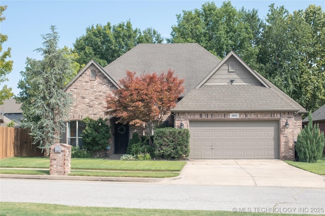 view of front of home featuring a garage and a front yard