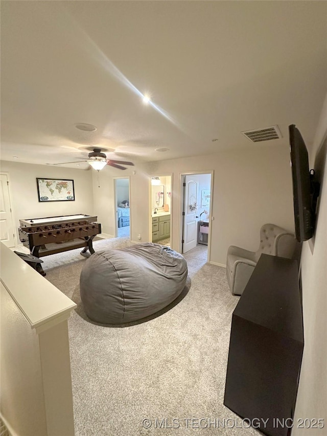 carpeted living room featuring ceiling fan