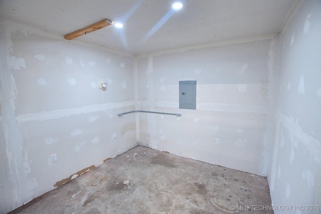 unfurnished room with electric panel and concrete floors