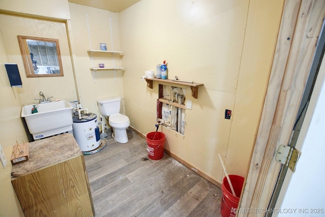 bathroom with sink, wood-type flooring, a bathing tub, and toilet