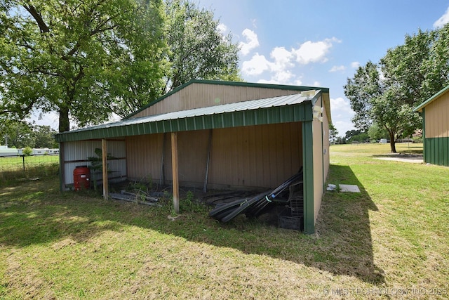 view of outbuilding featuring a lawn