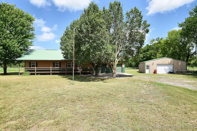 view of yard with a garage and an outbuilding