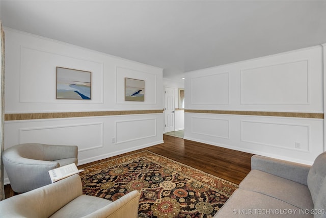 living room with ornamental molding and wood-type flooring