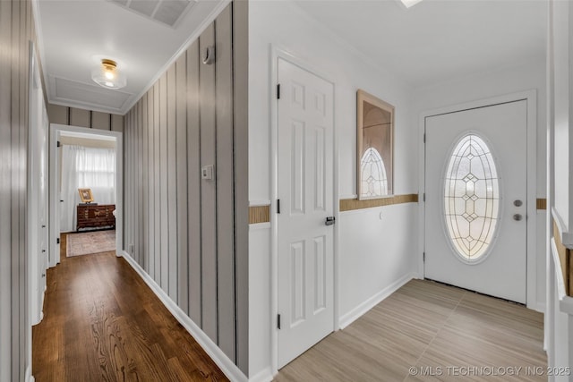 entrance foyer featuring crown molding and a healthy amount of sunlight