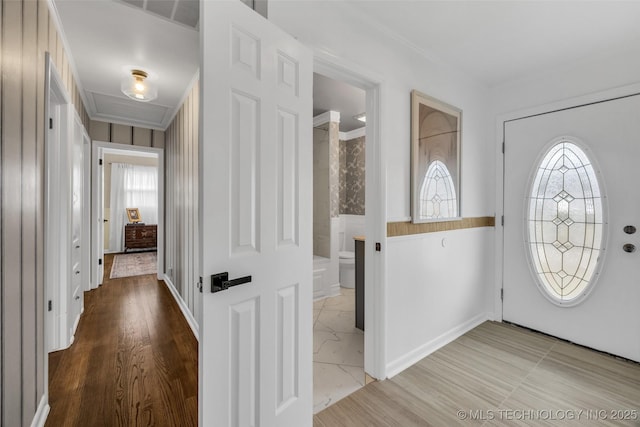 foyer featuring a wealth of natural light and ornamental molding