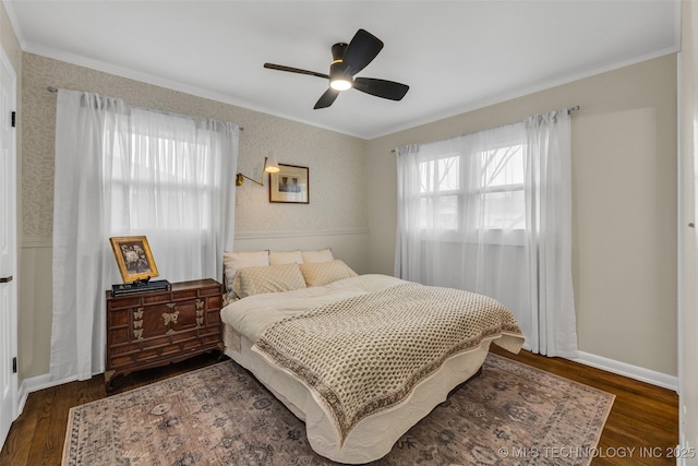 bedroom featuring ceiling fan, ornamental molding, and dark hardwood / wood-style flooring