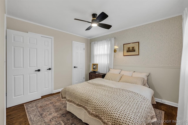 bedroom featuring ornamental molding, ceiling fan, and dark hardwood / wood-style flooring