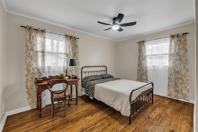 bedroom with ornamental molding, dark hardwood / wood-style floors, and ceiling fan