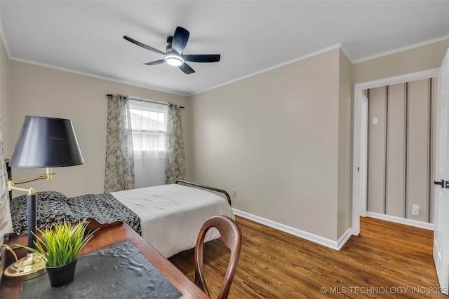 bedroom with hardwood / wood-style floors, ornamental molding, and ceiling fan