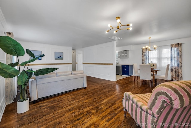 living room featuring dark hardwood / wood-style floors and a chandelier