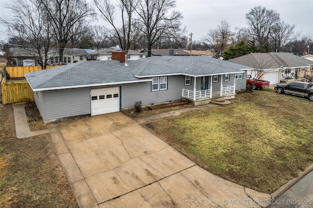 ranch-style home with a garage and a front lawn