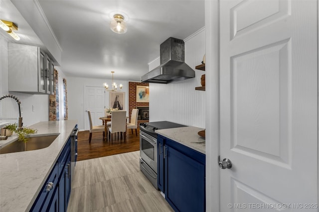 kitchen with blue cabinets, sink, stainless steel range with electric stovetop, light stone countertops, and wall chimney range hood