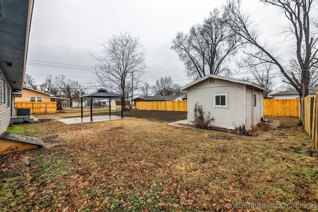 view of yard featuring a gazebo, an outdoor structure, and central AC unit