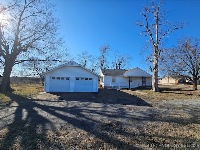 view of front of house with a garage and an outdoor structure