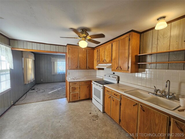 kitchen featuring wood walls, sink, backsplash, electric range, and ceiling fan