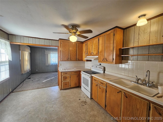 kitchen with wooden walls, tasteful backsplash, sink, white electric range oven, and ceiling fan