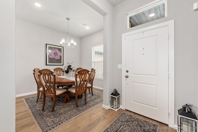 dining room featuring a chandelier and light hardwood / wood-style floors