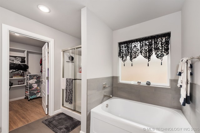 bathroom featuring hardwood / wood-style flooring and shower with separate bathtub