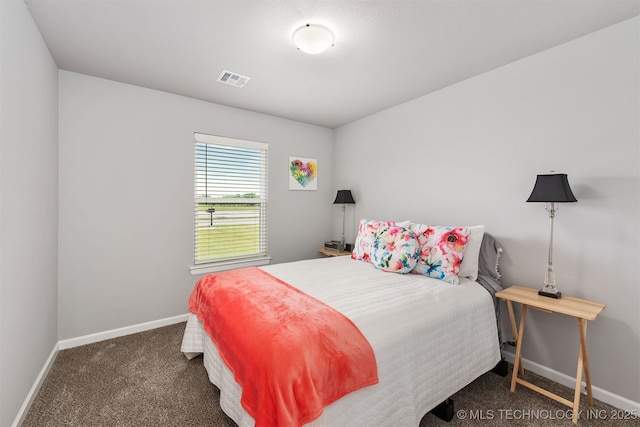 bedroom featuring dark colored carpet