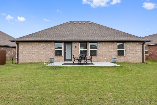 rear view of property featuring a lawn and a patio