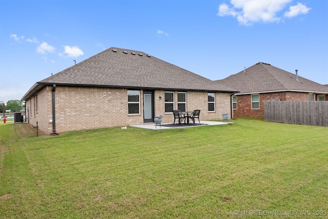 rear view of house featuring a patio area, a lawn, and central air condition unit