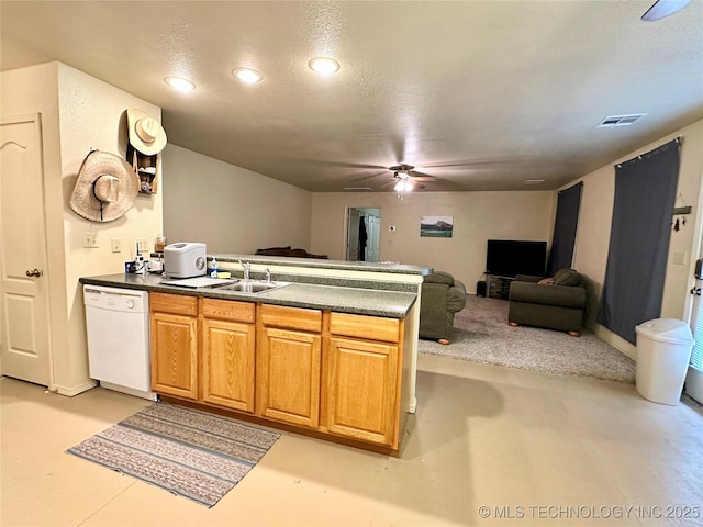 kitchen featuring ceiling fan, dishwasher, sink, and a textured ceiling